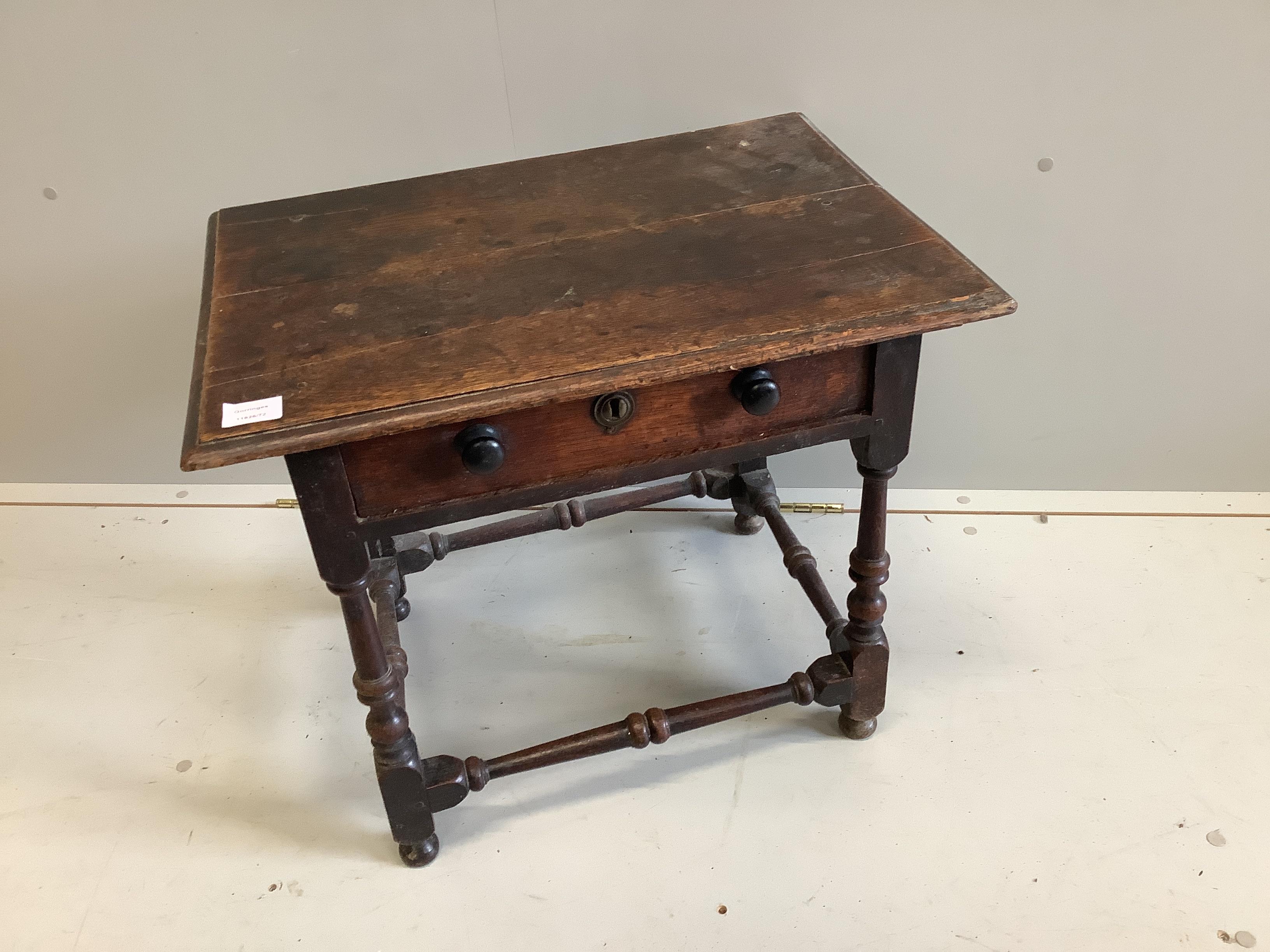 A small 18th century rectangular oak side table with planked top and single frieze drawer, width 63cm, depth 46cm, height 54cm